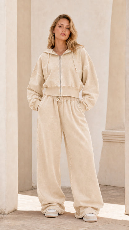 Full front view of model wearing sand beige cropped zip hoodie and wide leg sweatpants set