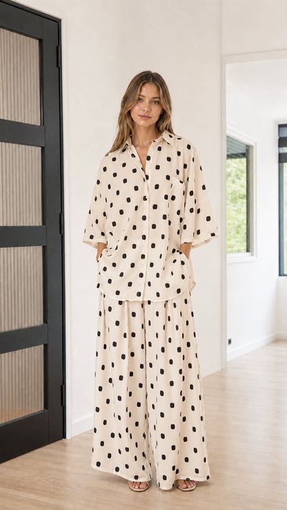 Front view of model wearing beige and black polka dot matching loungewear set