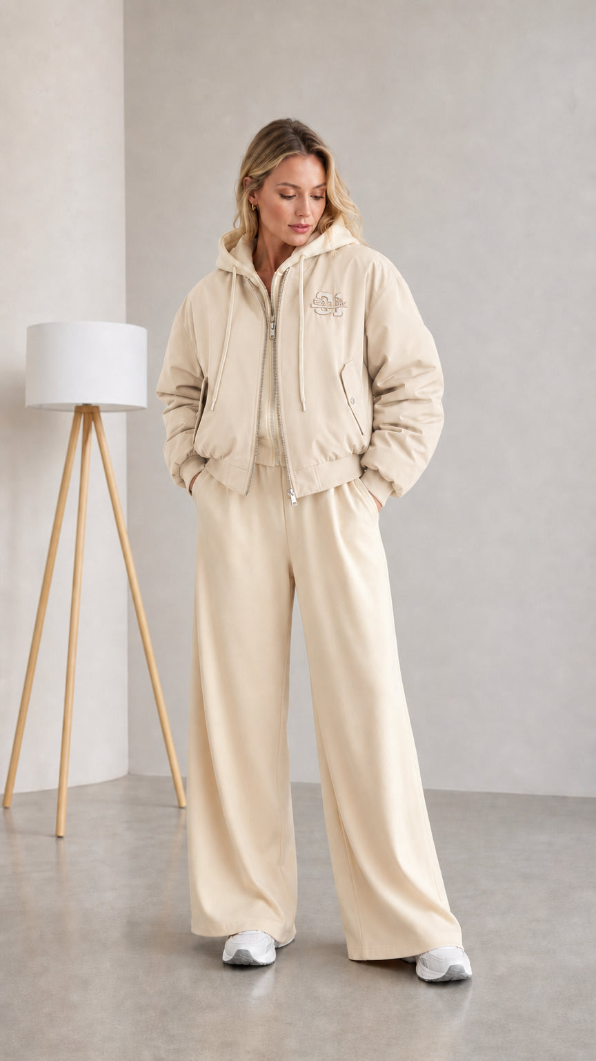 Woman wearing beige layered hooded bomber jacket