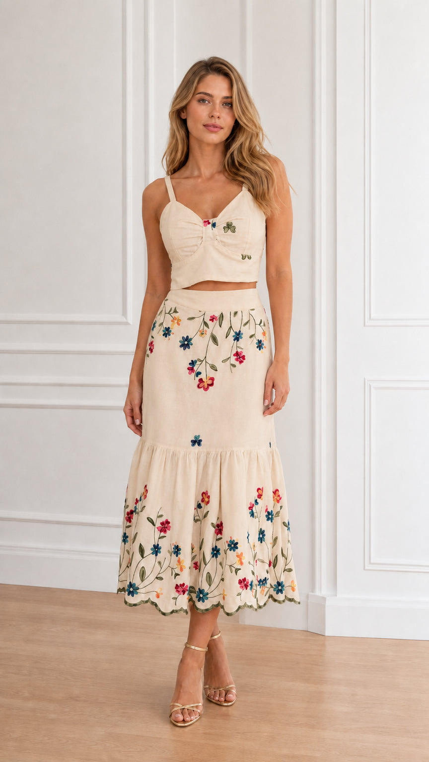 Model wearing beige floral embroidered crop top and tiered midi skirt set