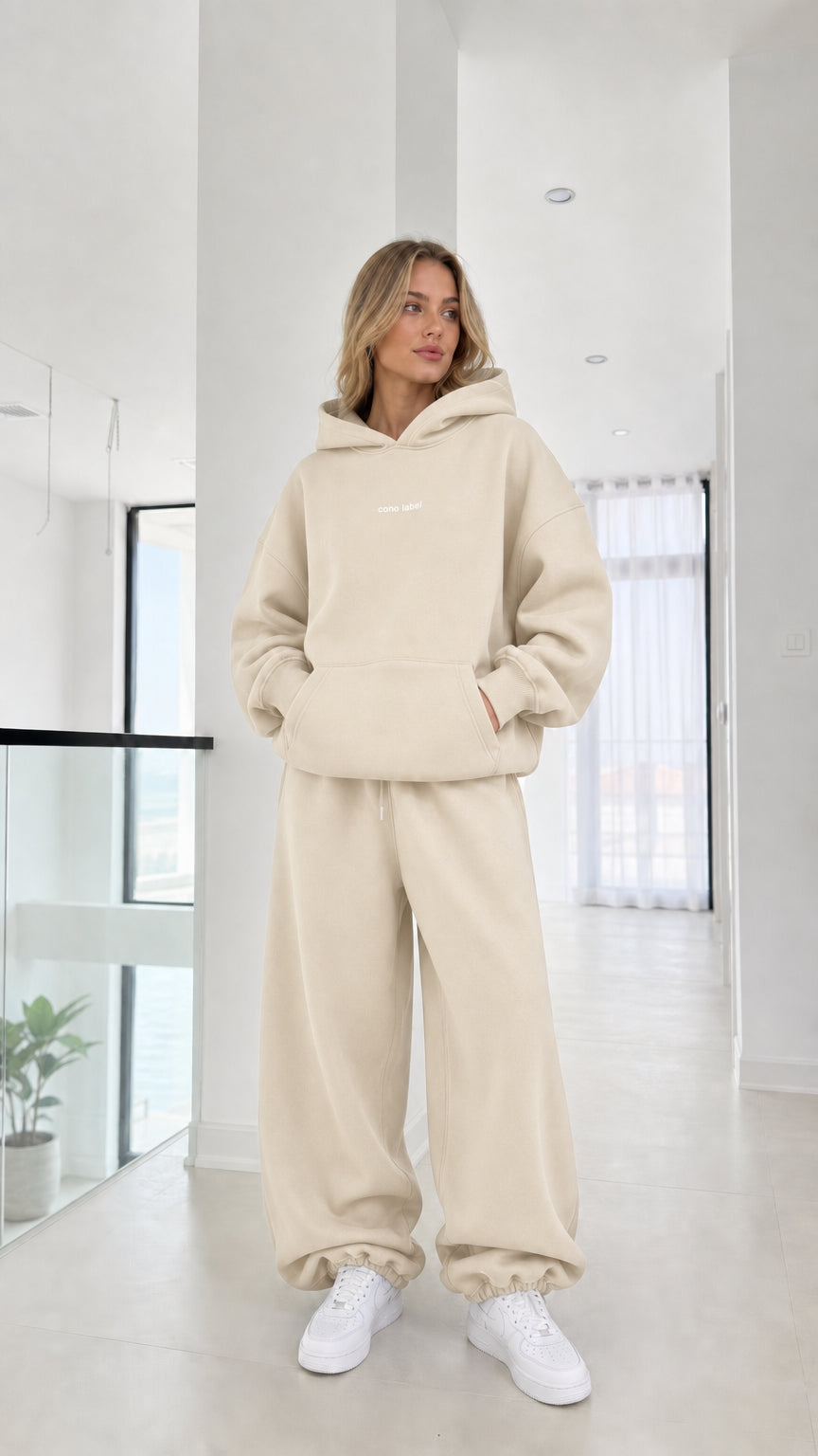 Full-length view of model wearing the cream beige fleece hoodie and sweats set