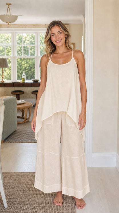 Front view of woman wearing cream beige handkerchief top and wide leg pants set