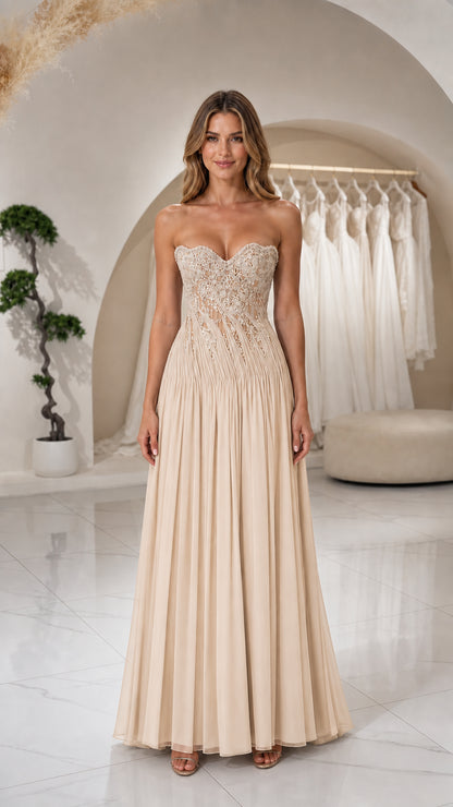 Front view of woman wearing Champagne strapless beaded corset pleated evening gown