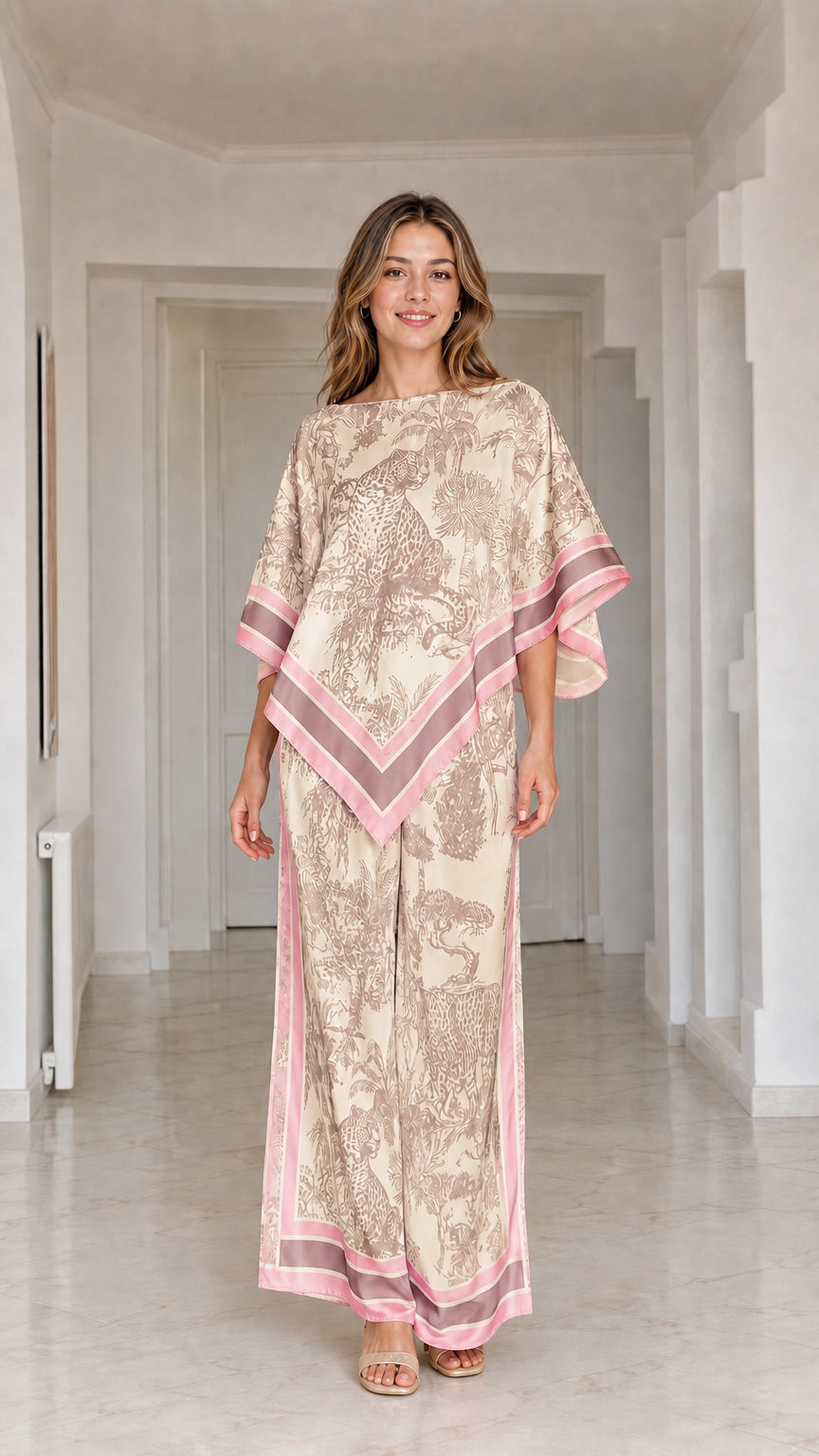 Model wearing champagne beige and pink printed poncho top and matching wide leg pants set