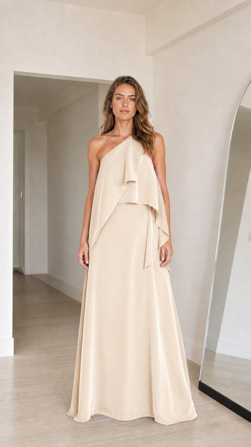 Model wearing champagne cream one-shoulder tiered draped maxi dress