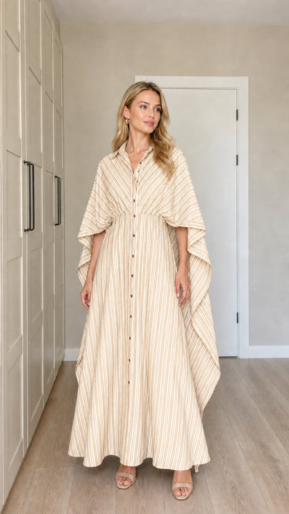 Front view of woman wearing beige tan striped button-down cape maxi dress