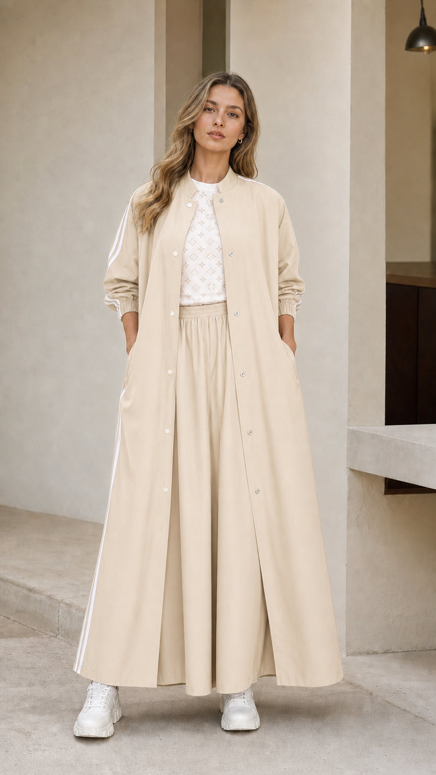 Woman wearing beige cream sporty maxi duster jacket and wide leg pants set