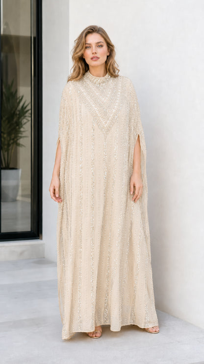 Model wearing champagne beige sequin embellished cape maxi dress