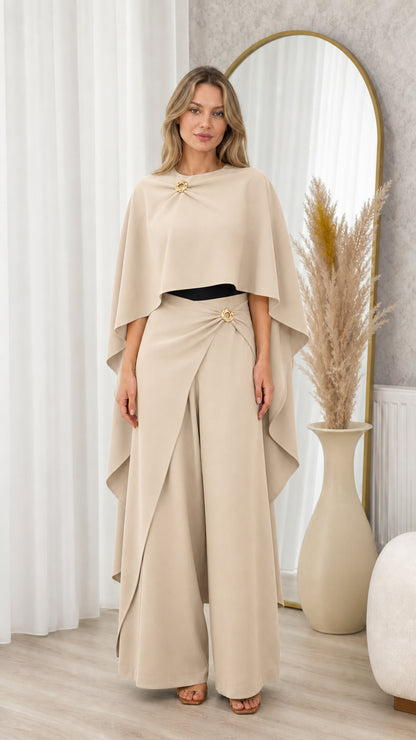 Full front view of beige champagne draped cape top and wide-leg trousers set