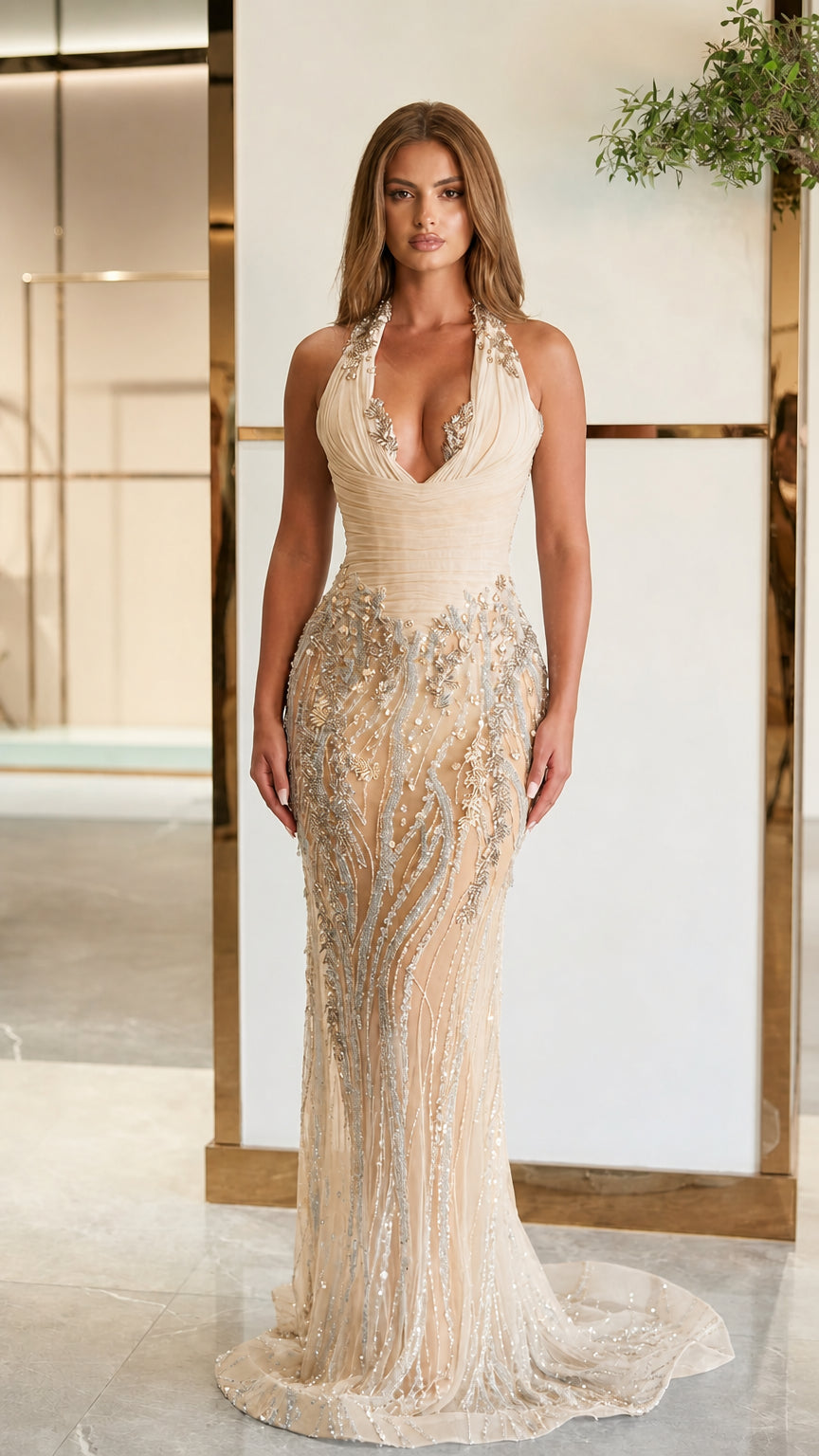 Front view of model in champagne gold halter plunge ruched bodice beaded mermaid gown