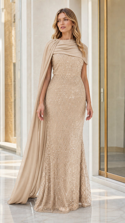 Full front view of champagne gold sequin mermaid gown with flowing cape drape